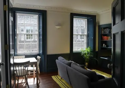 a living room with a couch and a table at Thistle Suite city centre in Edinburgh