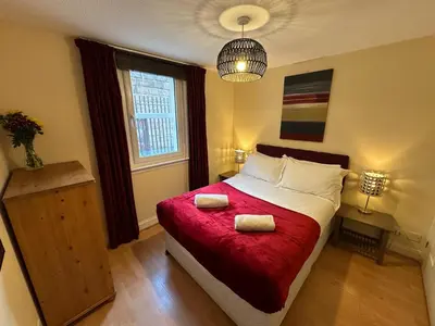 a bedroom with a bed with two towels on it at Castle Wynd Old Town in Edinburgh