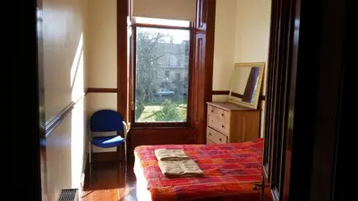 a bedroom with a bed and a window at Broompark House in Glasgow