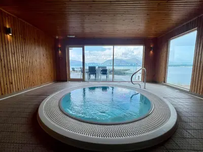 a jacuzzi tub in a room with a view at Loch Linnhe Waterfront Lodges with Hot Tubs in Glencoe