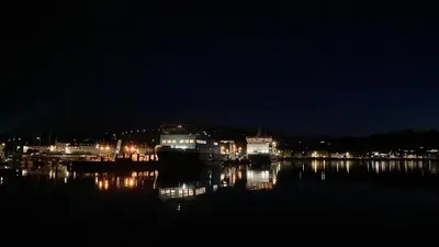 a city at night with lights on the water at Cannon House Guest House in Rothesay