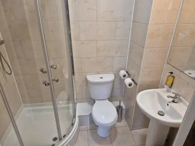 a bathroom with a shower and a toilet and a sink at Douglas Hotel in Glasgow