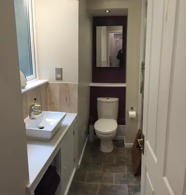 a bathroom with a toilet and a sink and a mirror at Artisan Studio in Tarbert