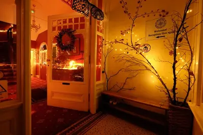 a hallway with a door with christmas lights at Moffat Independent Hostel in Moffat