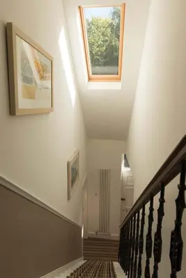 a hallway with a staircase with a skylight at Forth Reflections Self Catering in Queensferry