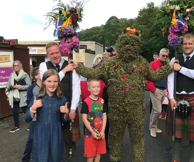a man dressed in a plant costume with a little girl at Forth Reflections Self Catering in Queensferry