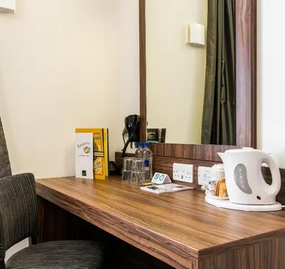 a desk in a hotel room with a coffee maker on it at Highland Gate, Stirling by Marston's Inns in Stirling
