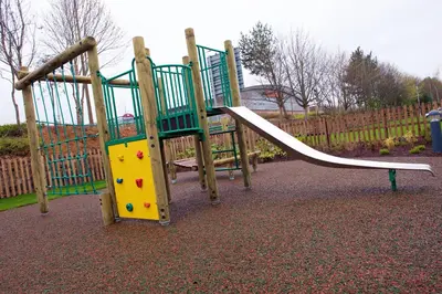 a playground with a slide in a park at Chain Runner, Livingston by Marston's Inns in Livingston