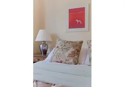 a bedroom with a bed with a pillow and a lamp at The Edinburgh Address - Classic Marchmont Charm in Edinburgh