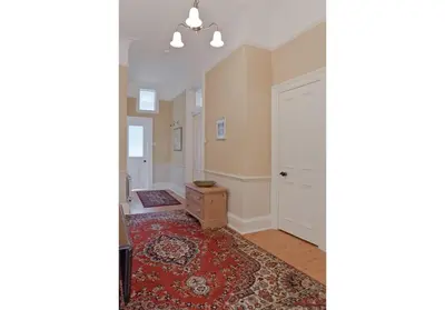 an empty room with a door and a rug at The Edinburgh Address - Classic Marchmont Charm in Edinburgh