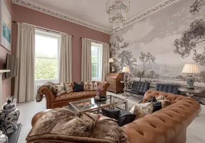 a living room with a large painting on the wall at Edinburgh Castle Suite - The Edinburgh Address in Edinburgh