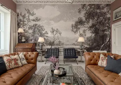 a living room with couches and a wall mural at Edinburgh Castle Suite - The Edinburgh Address in Edinburgh