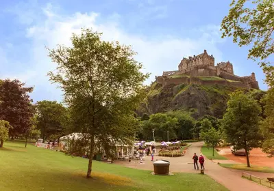 a park with a castle on top of a hill at Edinburgh Castle Suite - The Edinburgh Address in Edinburgh