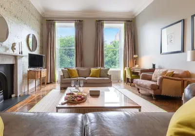 a living room with a couch and a table at The Edinburgh Address - Castle View Apartment in Edinburgh