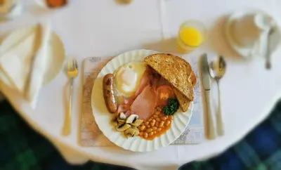 a plate of food with eggs and beans on a table at Brig O'Doon Guest House in Edinburgh