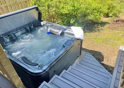 a hot tub in the back of a backyard at Ash Lodge in Benmore