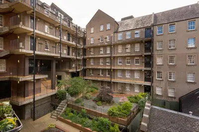 an apartment building with a garden in the courtyard at The Wee Thistle in Edinburgh