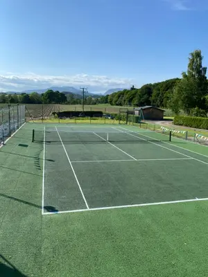 a tennis court with a net on top of it at Spacious cottage - walk to Crieff in Crieff