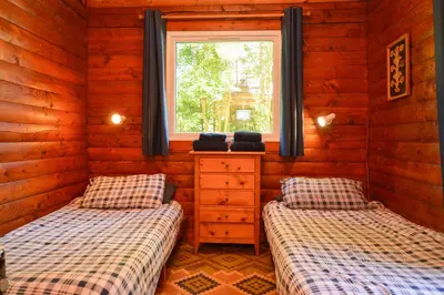 two twin beds in a room with a window at 18 Lamont Lodges in Dunoon