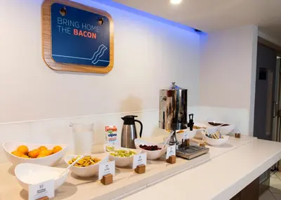a kitchen counter with bowls of food on it at Holiday Inn Express - Glasgow Airport by IHG in Paisley