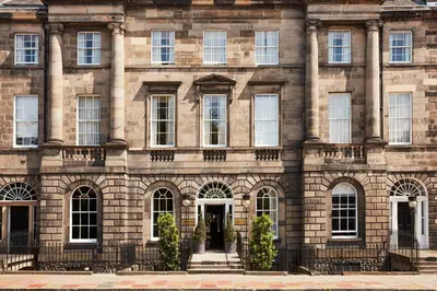a large brick building with a door in front at Kimpton Charlotte Square by IHG in Edinburgh