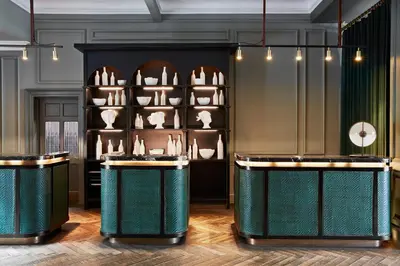 a room with two tables and a shelf with vases at Kimpton Charlotte Square by IHG in Edinburgh