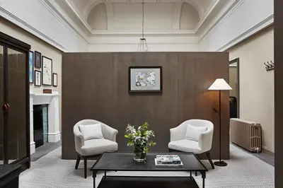 a living room with two chairs and a table at Kimpton Charlotte Square by IHG in Edinburgh