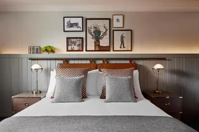 a bedroom with a white bed with three pillows at Kimpton Charlotte Square by IHG in Edinburgh