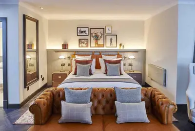 a large bedroom with a large bed with a leather headboard at Kimpton Charlotte Square by IHG in Edinburgh