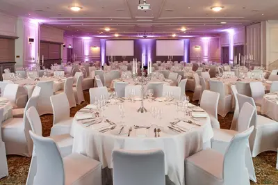a ballroom with white tables and white chairs at Kimpton Charlotte Square by IHG in Edinburgh