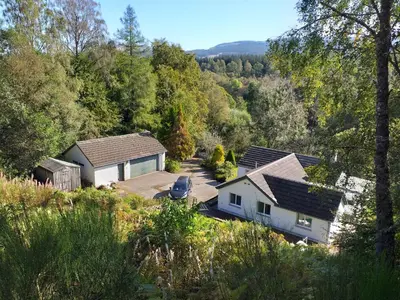 an aerial view of a house in the woods at Craignavie Cottage in Killin