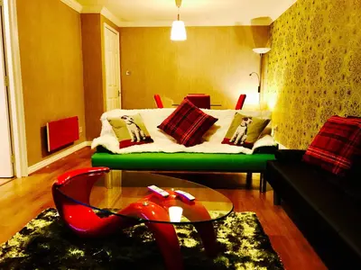 a living room with a bed and a coffee table at Glasgow City Centre Flat with River Views and Parking in Glasgow