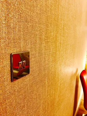 a door with a switch on a wall at Glasgow City Centre Flat with River Views and Parking in Glasgow