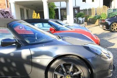 a row of parked cars parked in a row at Annandale Arms Hotel in Moffat