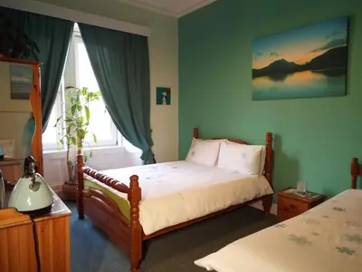 a bedroom with a bed and a window at Badjao B&B in Edinburgh
