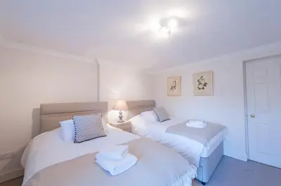 two beds in a room with white walls at Apartment Jamaica Street 7 in Edinburgh