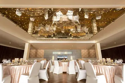 a banquet hall with white tables and white chairs at DoubleTree by Hilton Edinburgh - Queensferry Crossing in North Queensferry