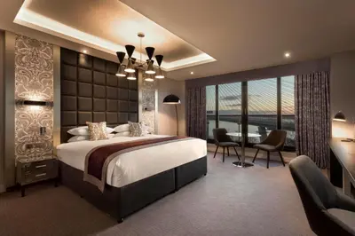 a bedroom with a large bed and a balcony at DoubleTree by Hilton Edinburgh - Queensferry Crossing in North Queensferry