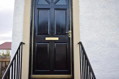 a black door on the side of a building at Kelpies Serviced Apartments - McClean in Falkirk
