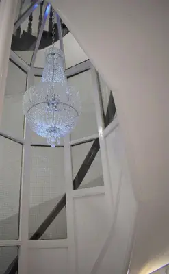 a chandelier hanging from a ceiling in a room at Kelpies Serviced Apartments in Falkirk