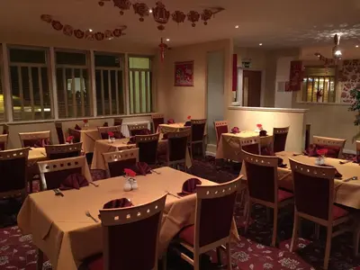 a dining room with tables and chairs and tablesearcher at Laughing Buddha Guesthouse in Uddingston