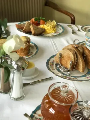 a table with plates of food on top of it at Glenegedale House in Kintra