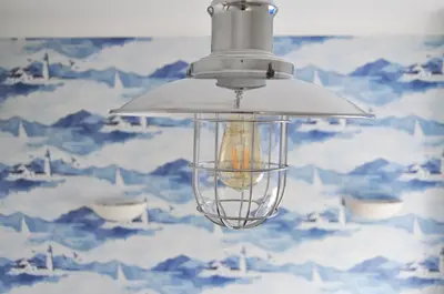 a light fixture hanging from a ceiling with mountains at No. 1 Charlotte Street in Port Ellen