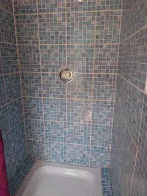 a blue tiled shower with a tub in a bathroom at MacDonald Cabins in Kinlochleven