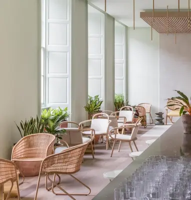 a room with chairs and tables and windows at Eden Locke in Edinburgh