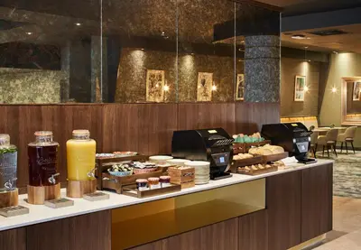a bakery counter with various pastries on display at Leonardo Royal Hotel Glasgow in Glasgow