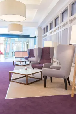 a living room with two chairs and a coffee table at The Golden Jubilee Hotel in Clydebank