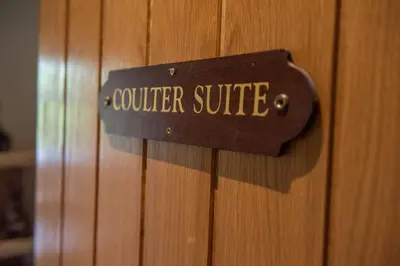 a sign that reads volunteer suite on a wooden door at Tinto Hotel in Symington