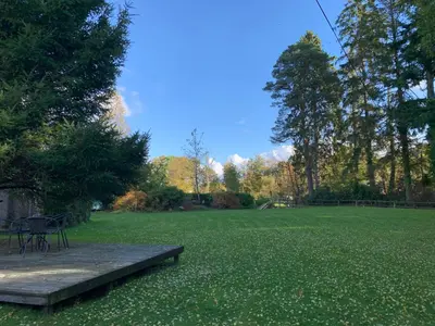 a park with a bench in the middle of a field at Creity Hall Chalet in Stirling