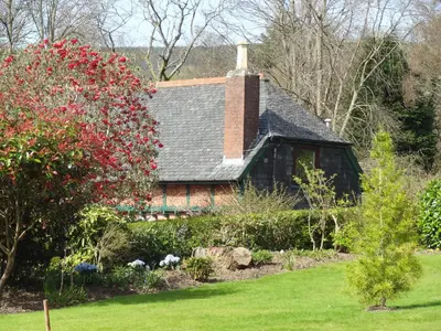 a house with a brick chimney and a garden at Coach House at The Glen in Helensburgh